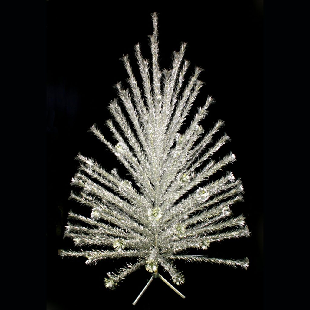 Evergleam aluminum Christmas tree, early 1960s Seven-foot silver pom-pom tree The first style of Evergleam branch featured straight needles, but in later years Aluminum Specialty made different styles such as the pom-pom tree. Curled needles gave these trees the appearance of having pom-pom balls at the end of their branches, resulting in fuller-looking trees with more surfaces to reflect light. WHS Museum #2005.162.1.1A-CY