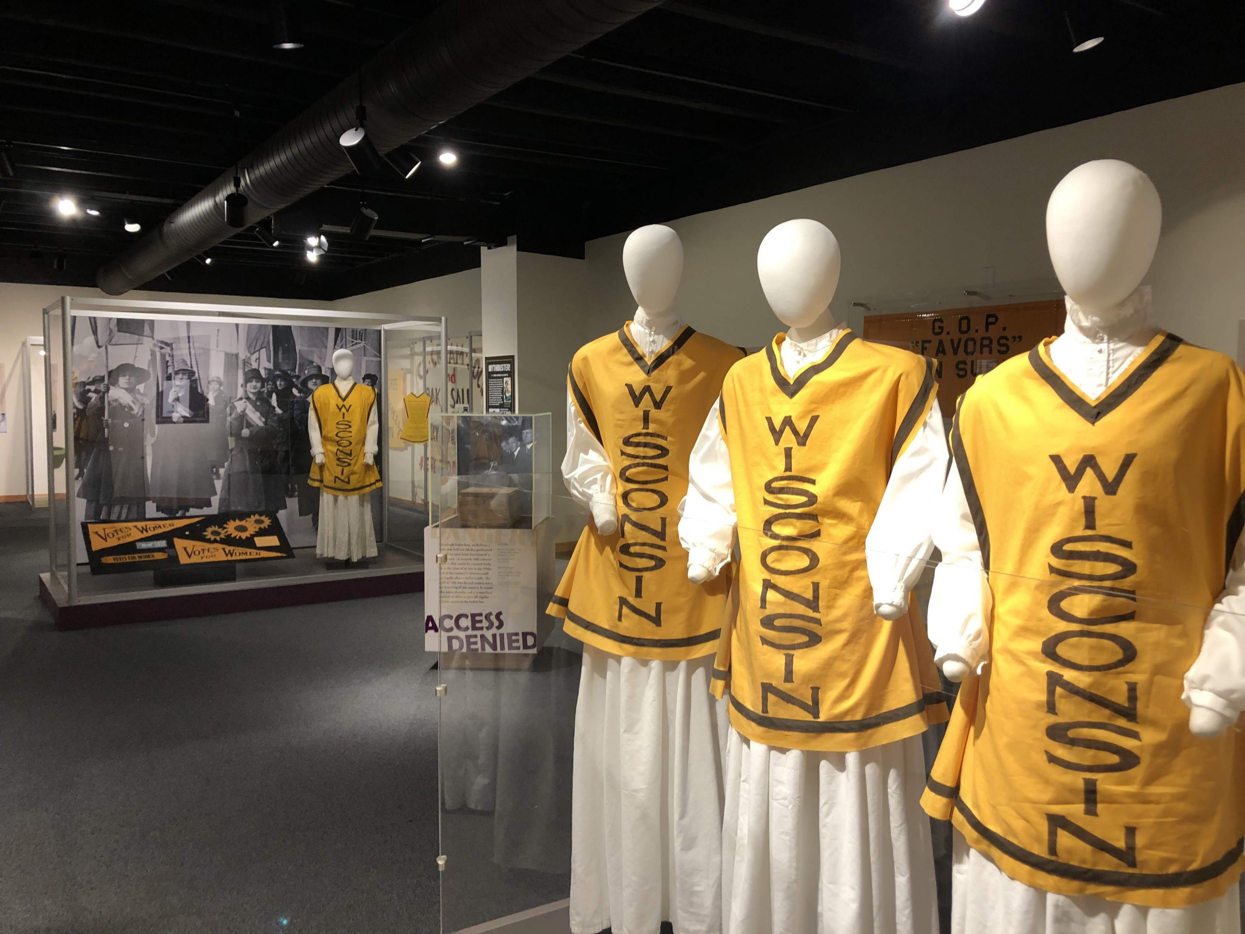 Iconic gold tunics, pennants, and accessories from the Wisconsin Woman Suffrage Association ca. 1910–1920.