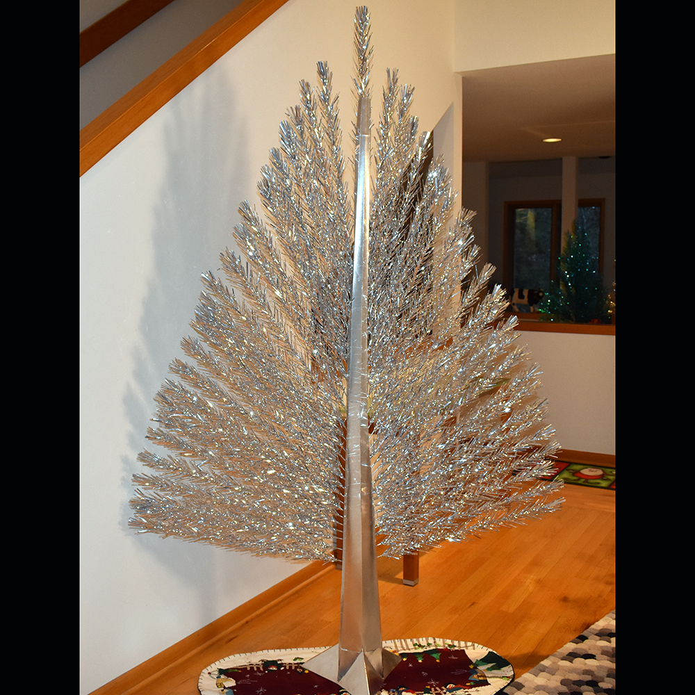 Seven-foot silver Peacock, Evergleam aluminum Christmas tree, mid-1960s. Designed to sit against a wall in tight spaces, this Evergleam is actually two-dimensional—the only model of its kind. The Peacock’s stand and pole are obscured by decorative cardboard covers, which are covered in foil and have clean lines and angles. The result is a very modern, space-age appearance. (Private collection)