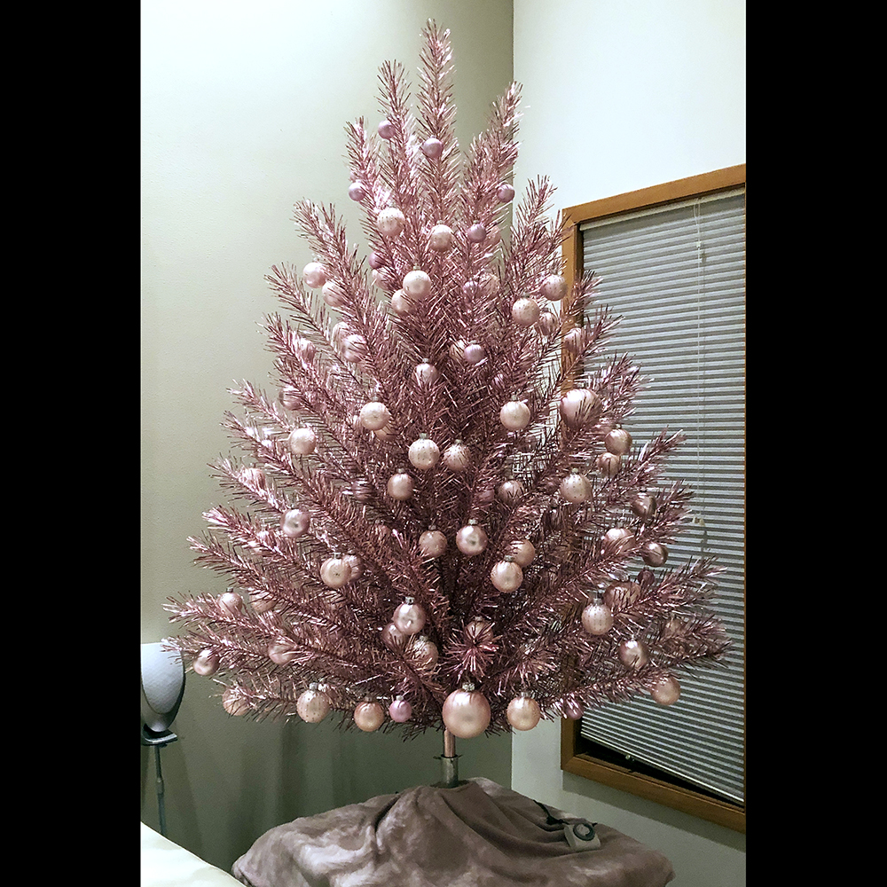 Seven-foot pink Evergleam aluminum Christmas tree, early to mid-1960s. Photographs of Evergleams and other aluminum Christmas trees from the 1960s and 1970s show that many people decorated their trees with traditional ornaments instead of using color light wheels or projectors. This image shows one of the many ways to decorate an Evergleam in the home. (Private collection)