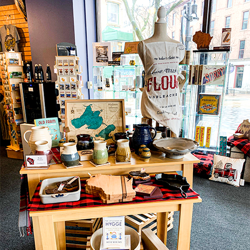 The Wisconsin HIstorical Museum store features a variety of different products, shown here are cutting boards, mugs, aprons and various other Wisconsin themed kitchen gear.