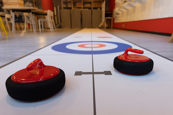 A curling decal set on the floor of the History Maker Space room for education